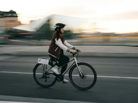 Commuter riding on a city road at sunrise