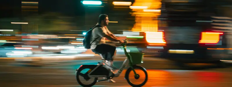 E-bike commuter riding past city lights at night