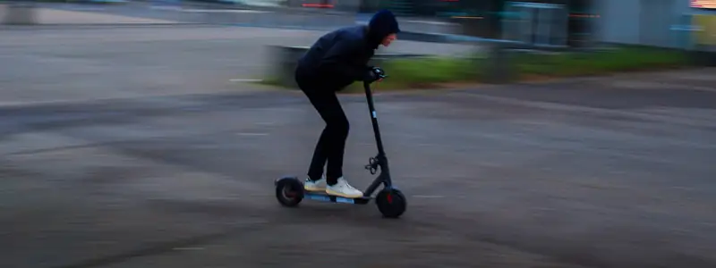 E-scooter rider in motion on a city street